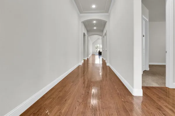 a view of livingroom with hallway and wooden floor