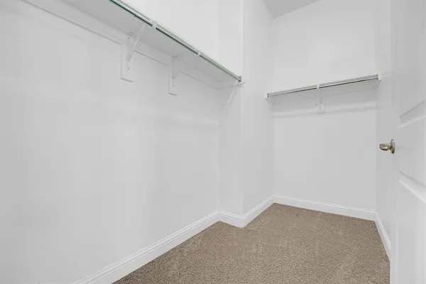 a bathroom with a toilet a window and a shower