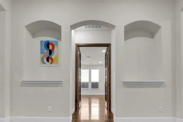 a view of a hallway with a dining room