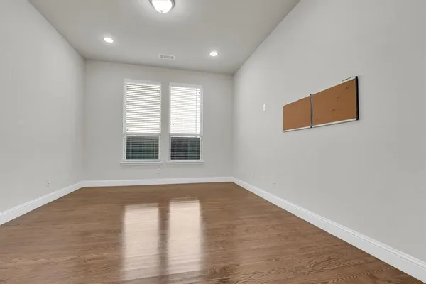 a view of an empty room with a gallery and wooden floor