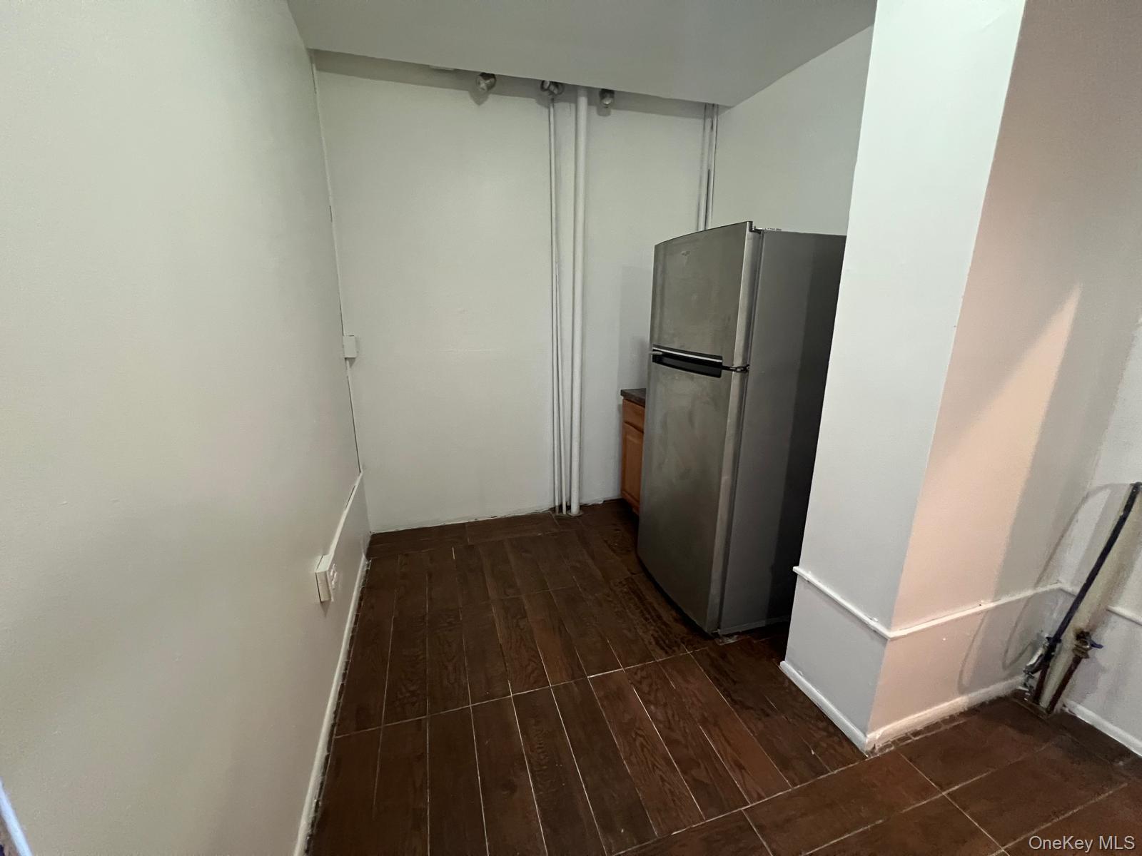 97-52 75th Street, Unit B1 Queens, NY 11416 - Photo 8 of 19 Kitchen featuring freestanding refrigerator and dark wood finished floors