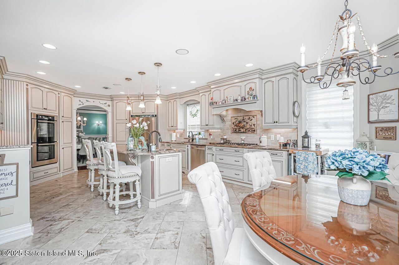 63 Finlay Avenue Staten Island, NY 10309 - Photo 16 of 45 a dining room with furniture and a kitchen view