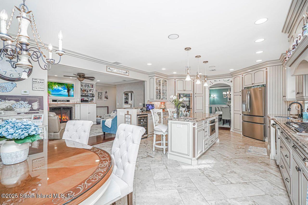 63 Finlay Avenue Staten Island, NY 10309 - Photo 20 of 45 a living room with furniture and a dining table with kitchen view