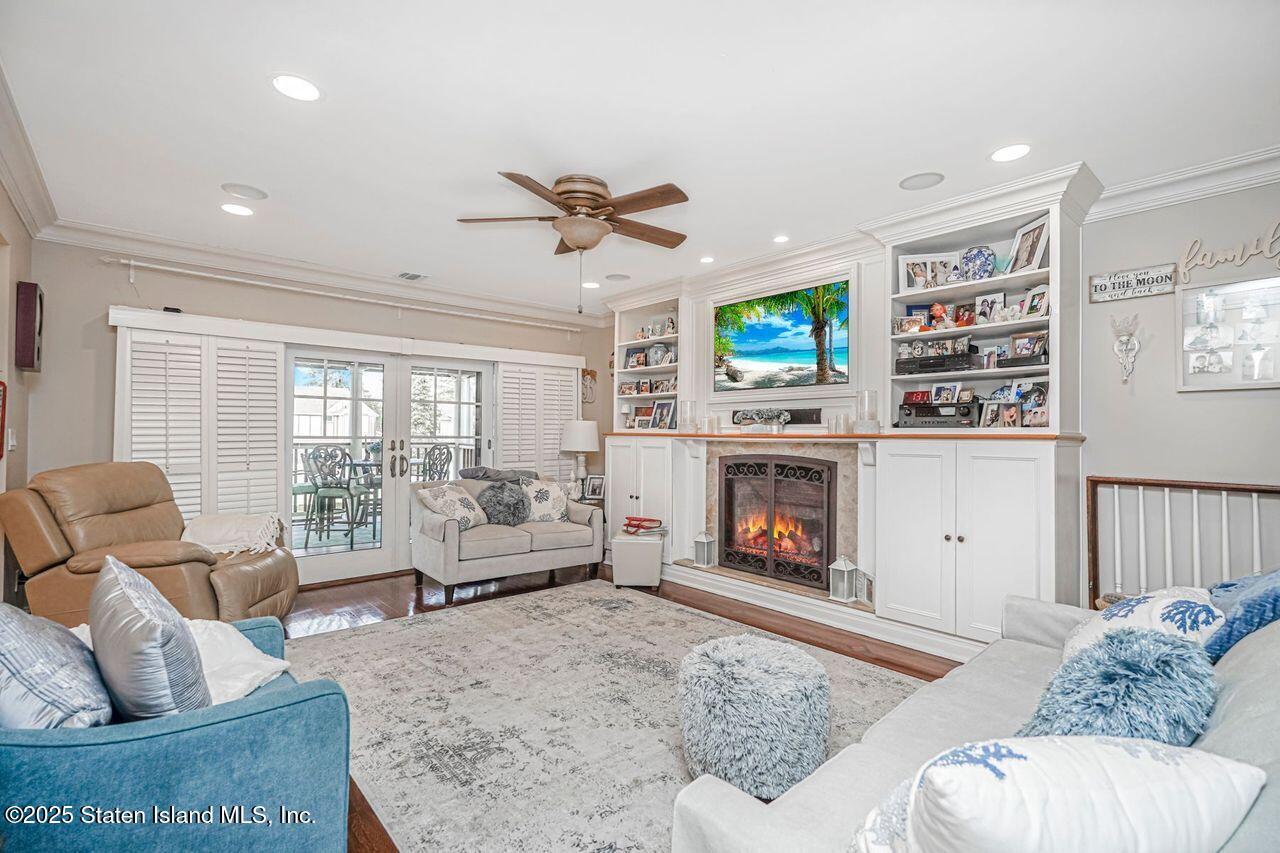 63 Finlay Avenue Staten Island, NY 10309 - Photo 22 of 45 a living room with furniture a fireplace and a flat screen tv
