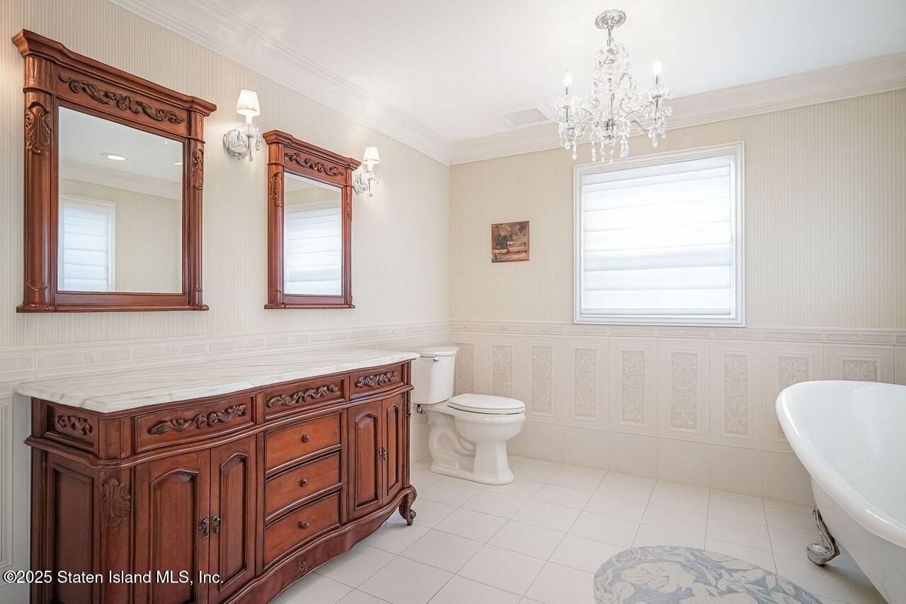 63 Finlay Avenue Staten Island, NY 10309 - Photo 31 of 45 a spacious bathroom with a toilet sink and mirror
