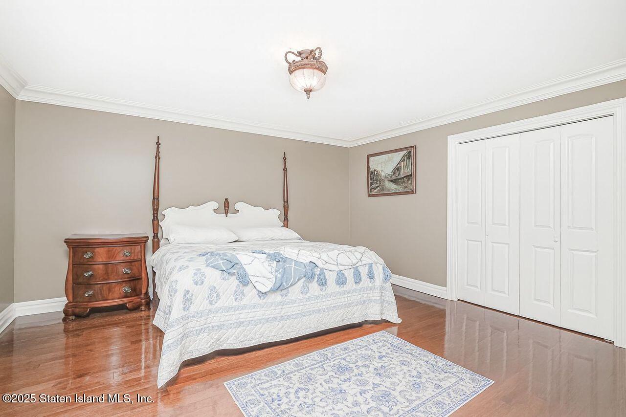 63 Finlay Avenue Staten Island, NY 10309 - Photo 33 of 45 a bedroom with a bed and a table