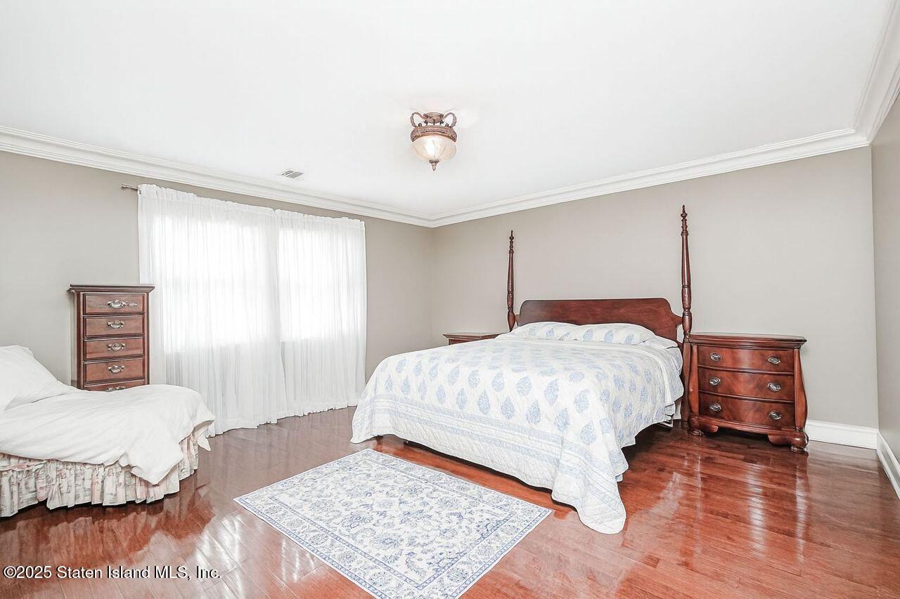 63 Finlay Avenue Staten Island, NY 10309 - Photo 34 of 45 a bedroom with a bed and wooden floor