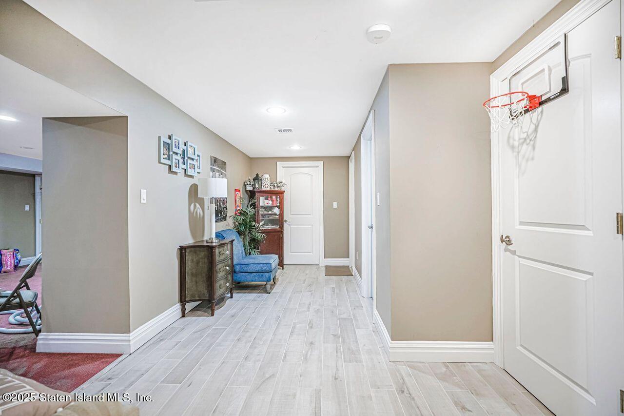 63 Finlay Avenue Staten Island, NY 10309 - Photo 37 of 45 a view of a workspace with furniture and wooden floor