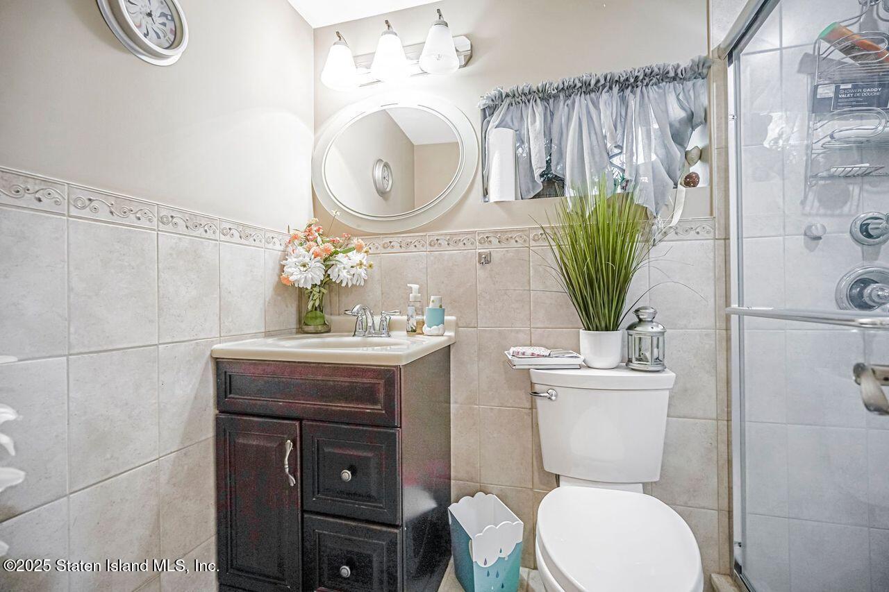 63 Finlay Avenue Staten Island, NY 10309 - Photo 38 of 45 a bathroom with a toilet a sink and a mirror