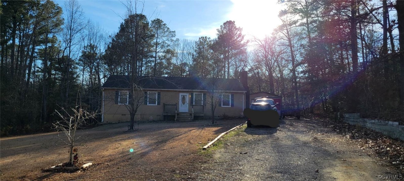 a view of a house with a yard and tree