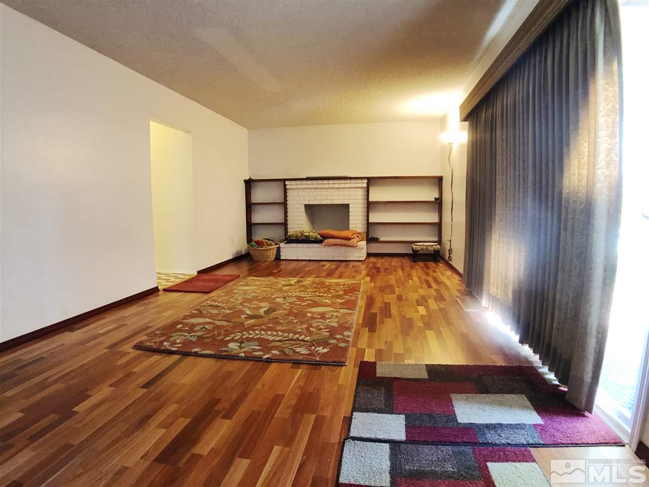4210 Billy Drive Reno, NV 89502 - Photo 23 of 31 a bedroom with a bed and wooden floor
