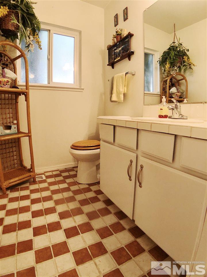 4210 Billy Drive Reno, NV 89502 - Photo 28 of 31 a bathroom with a sink a toilet and a mirror