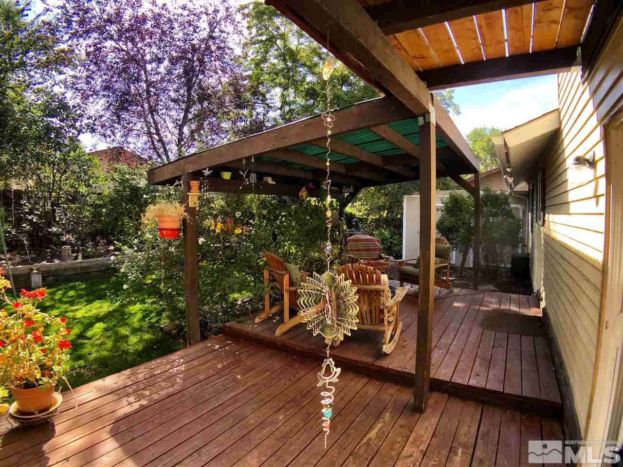 4210 Billy Drive Reno, NV 89502 - Photo 5 of 31 a view of a patio with table and chairs potted plants with wooden floor and fence