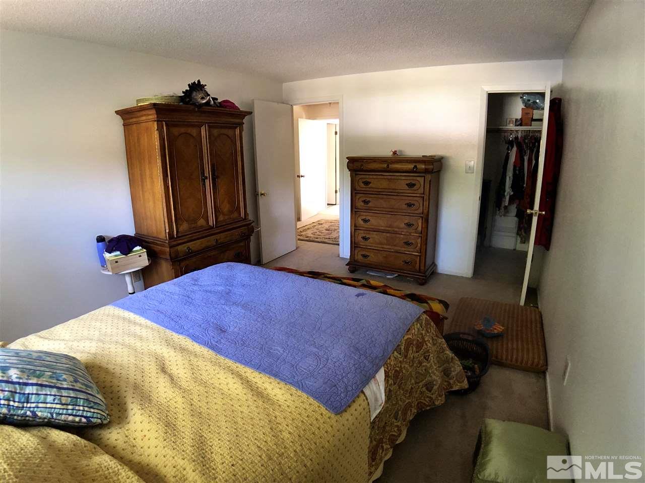 4210 Billy Drive Reno, NV 89502 - Photo 10 of 31 a bedroom with a bed and wooden floor