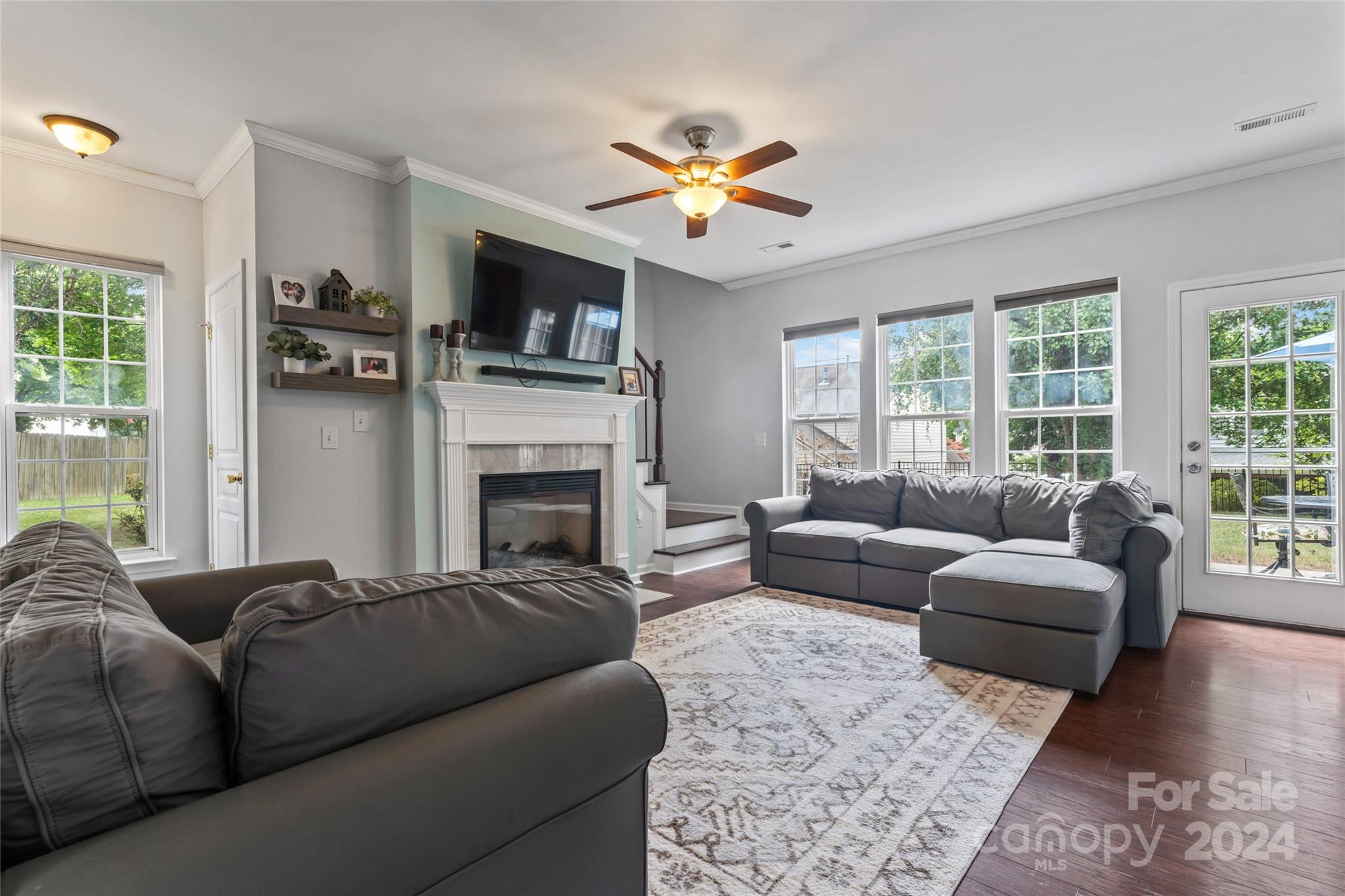 3144 Tanzanite Circle Fort Mill, SC 29708 - Photo 10 of 38 a living room with furniture a flat screen tv and a fireplace