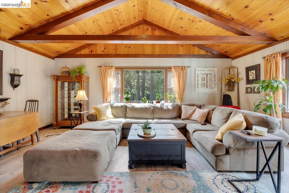 26144 Long Barn Road Long Barn, CA 95335 - Photo 5 of 42 Vaulted wood-paneled ceiling with exposed beams, wood-finish flooring, and multiple windows