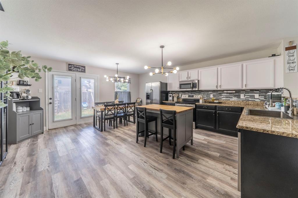 133 Adams Avenue Venus, TX 76084 - Photo 9 of 40 a kitchen with a sink a counter top space and stainless steel appliances