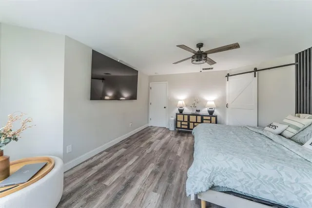 a kitchen with a dining table chairs stainless steel appliances and cabinets