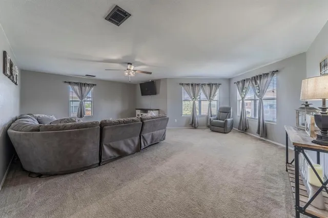 a spacious bedroom with a bed and a window