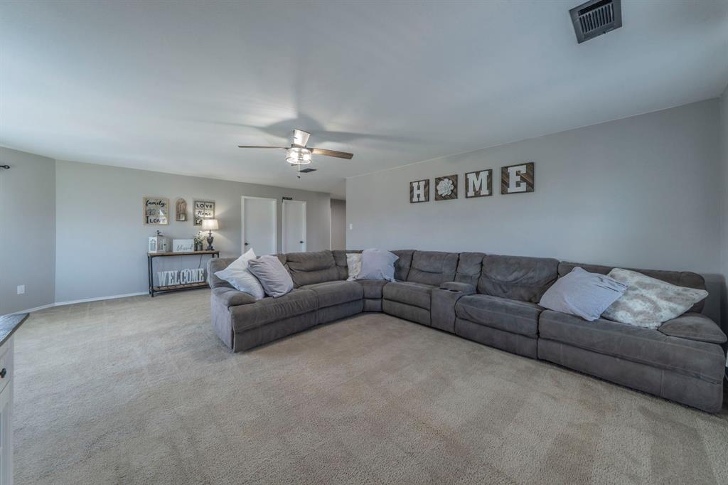 133 Adams Avenue Venus, TX 76084 - Photo 16 of 40 a living room with furniture and a ceiling fan