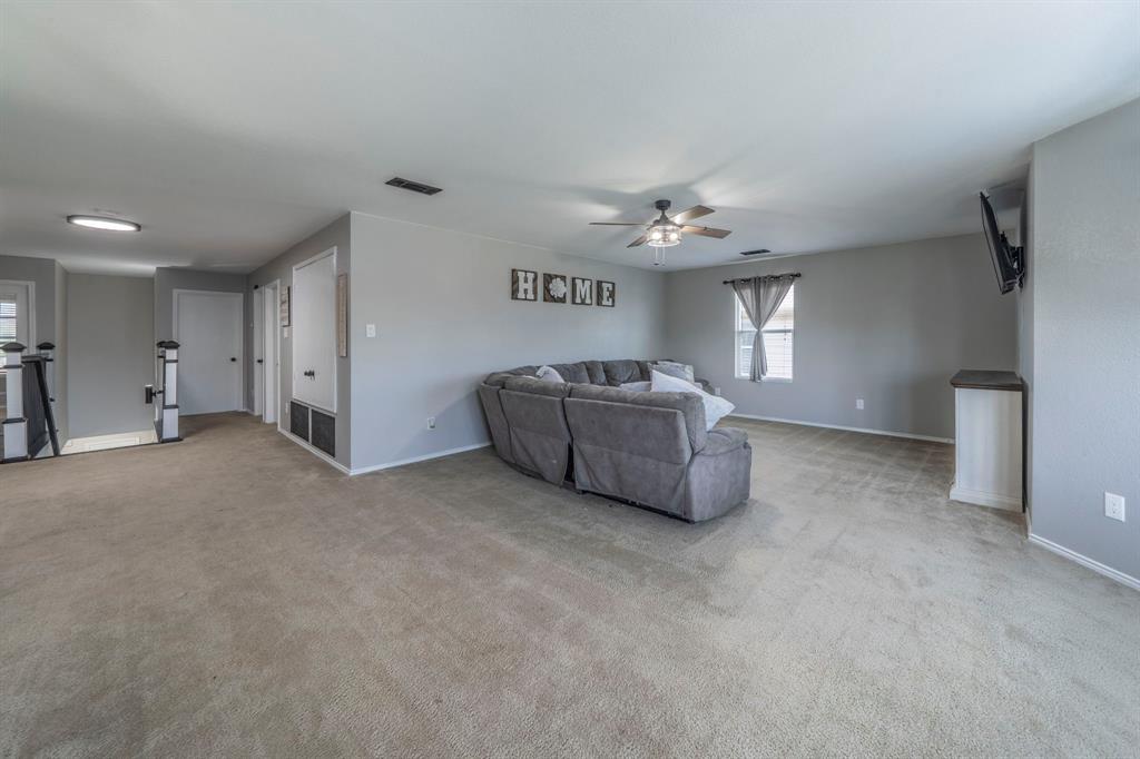 133 Adams Avenue Venus, TX 76084 - Photo 17 of 40 a living room with furniture and a chandelier