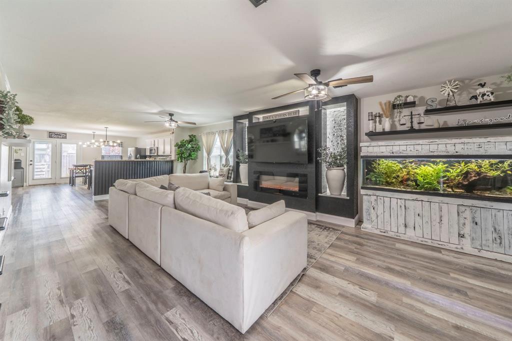 133 Adams Avenue Venus, TX 76084 - Photo 2 of 40 a living room with furniture a flat screen tv and a fireplace