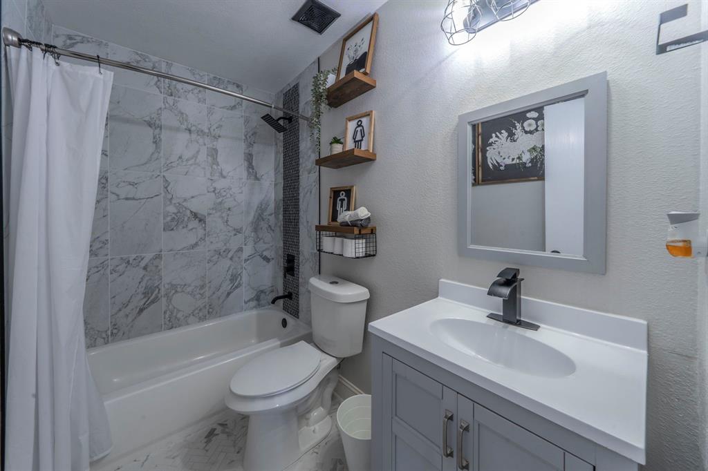 133 Adams Avenue Venus, TX 76084 - Photo 22 of 40 a bathroom with a sink toilet and shower