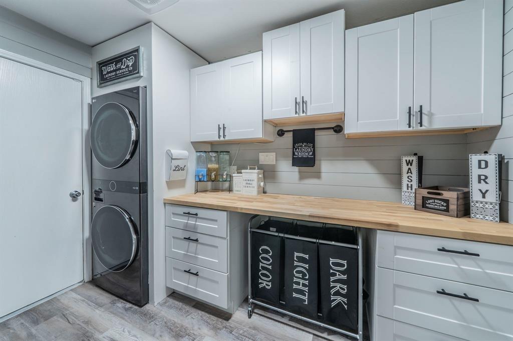 133 Adams Avenue Venus, TX 76084 - Photo 32 of 40 a kitchen with cabinets stainless steel appliances and a sink