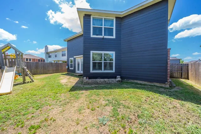 a view of a house with a yard and sitting area