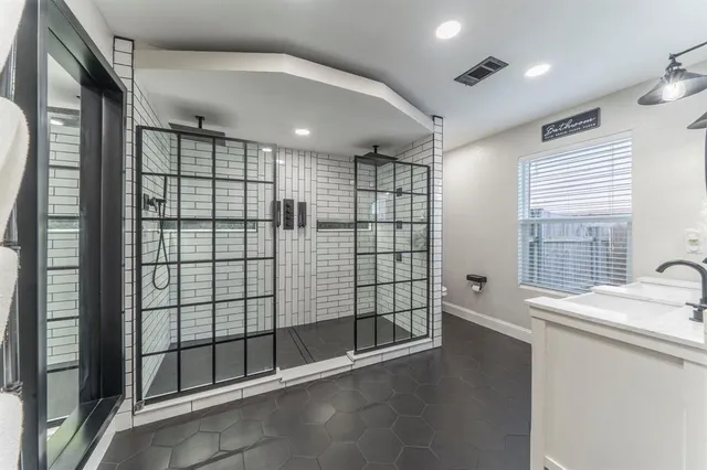 a kitchen with kitchen island a stove a sink a refrigerator dining table and chairs