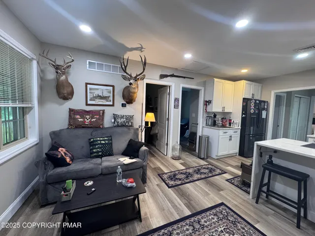 a bathroom with a toilet a sink a mirror a bathtub and vanity