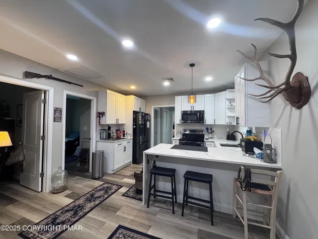 a living room with furniture and kitchen view