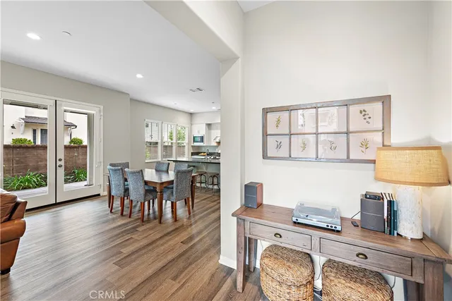 a living room with furniture a rug potted plant and a large window