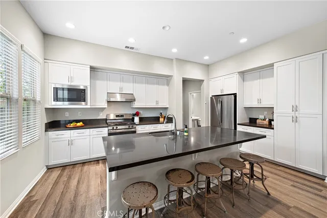 a living room with stainless steel appliances granite countertop furniture a kitchen view and kitchen island