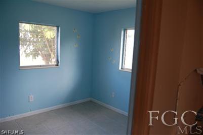 14 Arkansas Road Lehigh Acres, FL 33936 - Photo 3 of 7 an empty room with windows