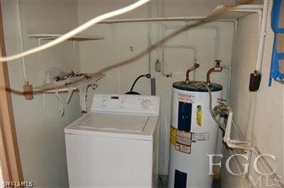 14 Arkansas Road Lehigh Acres, FL 33936 - Photo 7 of 7 a utility room with dryer and washer