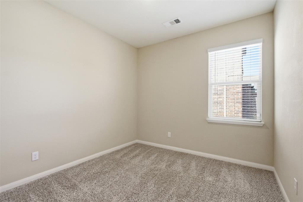 292 Wandering Stream Way Princeton, TX 75407 - Photo 19 of 40 Room featuring neutral-toned walls, textured carpet flooring, and a single window with horizontal blinds