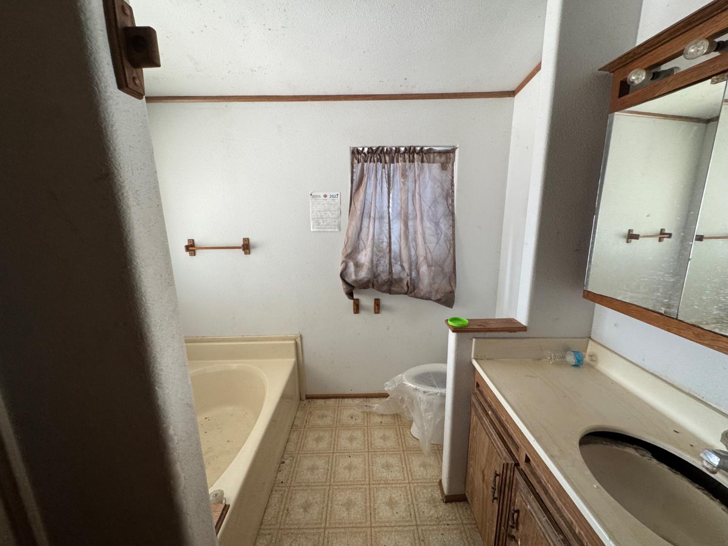 601 South Phillips Street Hanford, CA 93230 - Photo 10 of 18 a bathroom with a sink and a washing machine