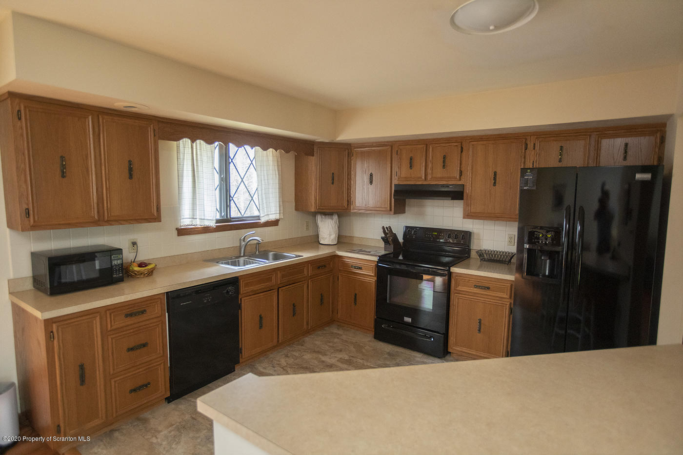 1420 Charles Road Lake Ariel, PA 18436 - Photo 12 of 47 a kitchen with a sink stove and refrigerator