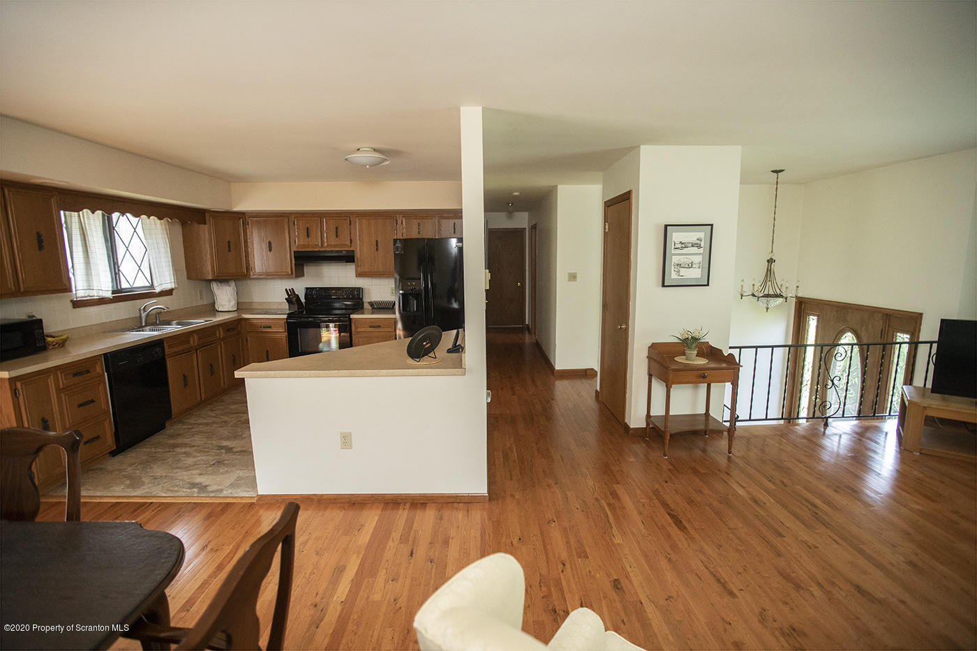 1420 Charles Road Lake Ariel, PA 18436 - Photo 13 of 47 a living room with furniture a dining table wooden floor and a large window
