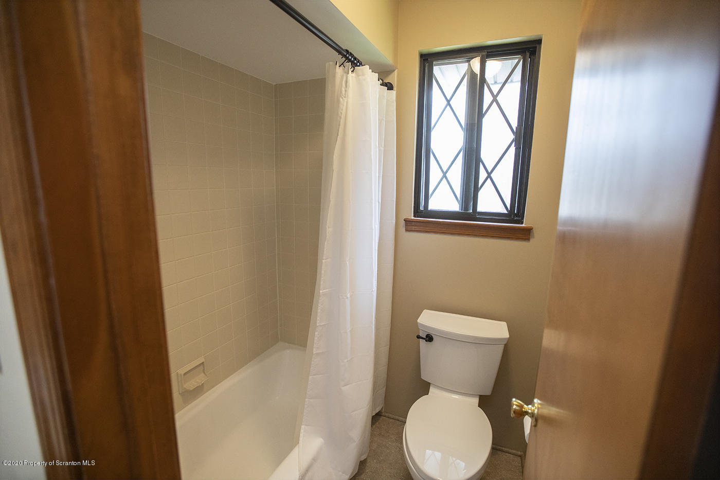 1420 Charles Road Lake Ariel, PA 18436 - Photo 18 of 47 a bathroom with a toilet and a shower curtain