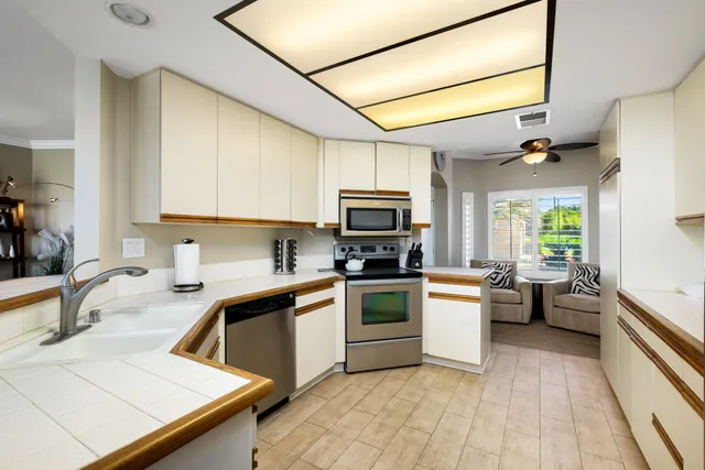 a kitchen with a sink appliances and cabinets