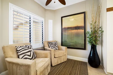 a bedroom with furniture and a large window