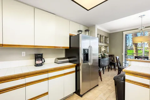 a kitchen with refrigerator and cabinets