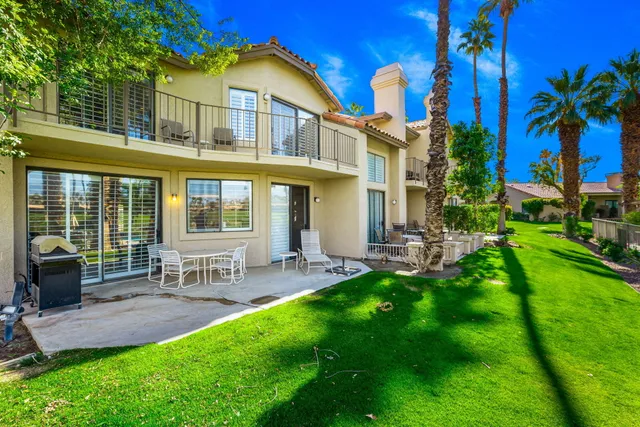 a view of an house with backyard porch and sitting area
