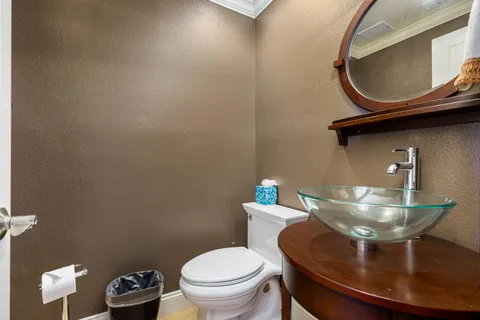 a bathroom with a toilet and a mirror