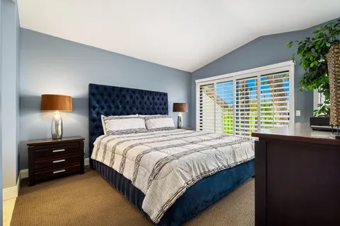 a bedroom with a bed and window