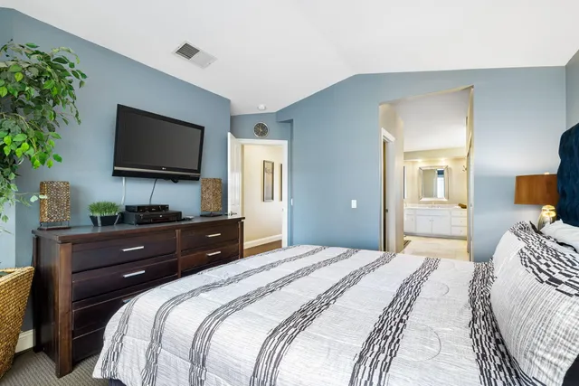 a bedroom with a bed window and a television