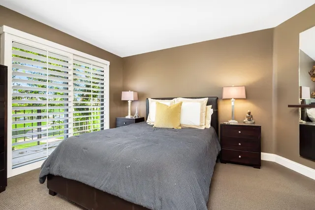 a bedroom with a bed and a lamp