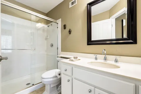 a bathroom with a sink toilet and shower